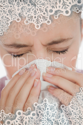 Composite image of woman blowing her nose