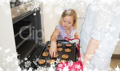Composite image of girl with mother baking cookies