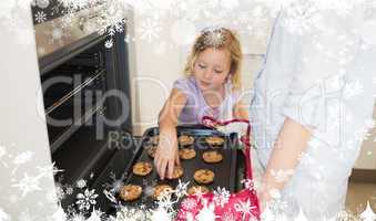 Composite image of girl with mother baking cookies