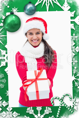 Composite image of beautiful festive woman offering gift