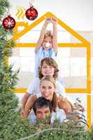 Composite image of family having fun with yellow drawing house