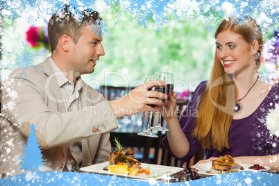 Composite image of cheerful couple having dinner together