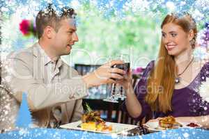 Composite image of cheerful couple having dinner together