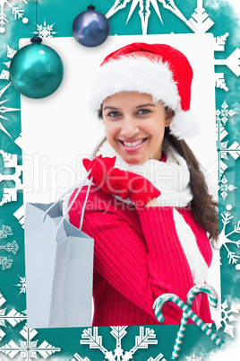 Composite image of beautiful festive woman holding shopping bag