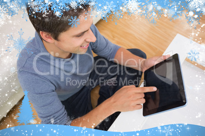 Overhead view of man using digital tablet in living room