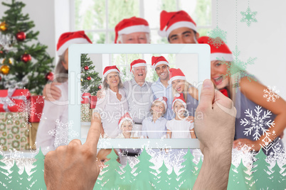 Composite image of hand holding tablet pc