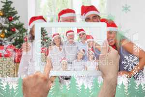 Composite image of hand holding tablet pc