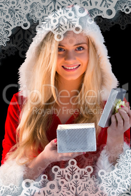 Pretty blonde in santa outfit opening gift