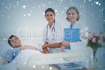 Composite image of two doctors and a patient looking at the came