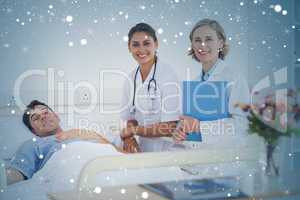 Composite image of two doctors and a patient looking at the came
