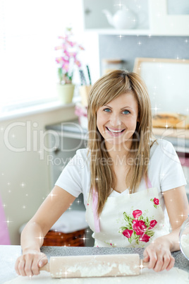 Portrait of a delighted woman preparing a cake in the kitchen