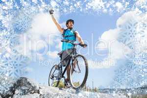 Fit man cycling on rocky terrain and cheering