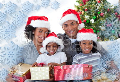 Composite image of family holding christmas presents