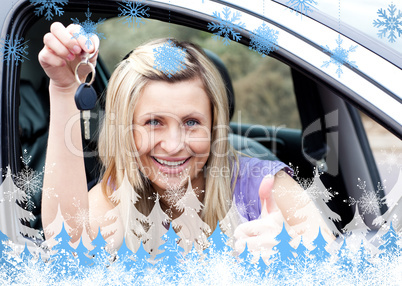 Charming female driver showing a key after bying a new car