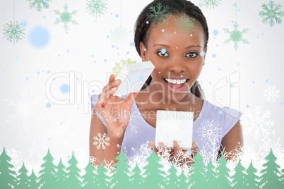 Close up of woman opening a present against a white background