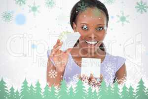 Close up of woman opening a present against a white background