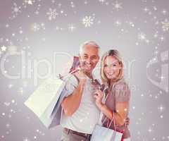 Happy couple with shopping bags and credit card