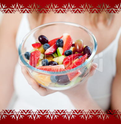 Close up of a woman eating a fruit salad