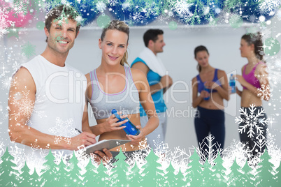 Couple holding clipboard with fitness class in background