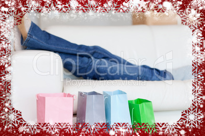 Female legs resting on sofa after shopping tour