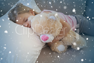 Girl sleeping on sofa with stuffed toy