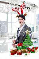 Smiling businesswoman with a novelty christmas hat drinking cham