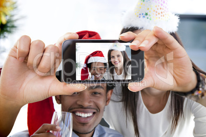 Composite image of hand holding smartphone showing