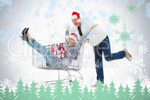 Festive mature couple in winter clothes with trolley and gifts