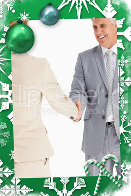 Composite image of happy business people shaking hands