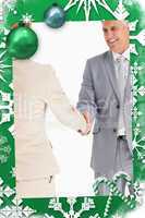 Composite image of happy business people shaking hands