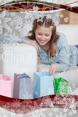 Woman on the sofa looking in her shopping bags