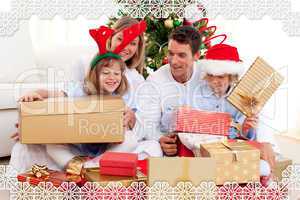 Young family having fun with christmas gifts