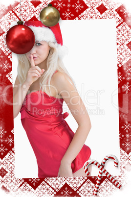 Composite image of young woman wearing santa hat with finger on