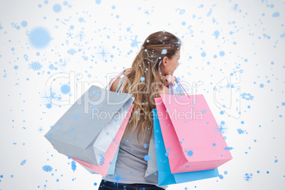 Back view of a woman holding shopping bags
