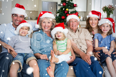 Composite image of family in santa hats celebrating christmas