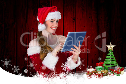 Composite image of pretty santa girl using tablet pc