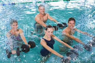 Happy fitness class doing aqua aerobics with foam dumbbells