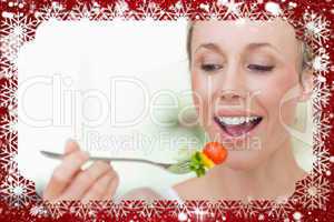 Composite image of woman eating a tomato