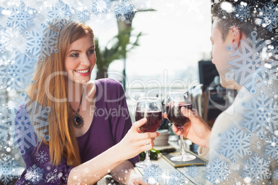 Composite image of cheerful couple having glass of wine together