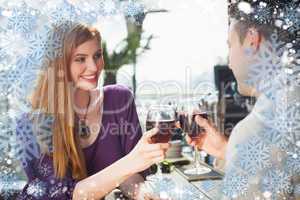 Composite image of cheerful couple having glass of wine together