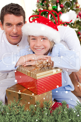 Portrait of a father and his son holding christmas presents