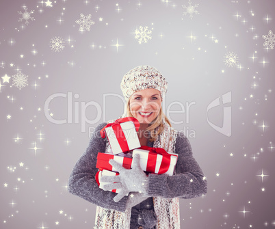Composite image of happy blonde with gifts