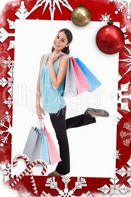 Portrait of a cheerful woman posing with shopping bags