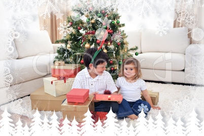 Composite image of happy children celebrating christmas at home