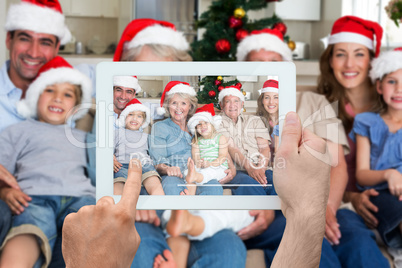 Composite image of hand holding tablet pc