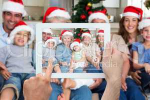 Composite image of hand holding tablet pc