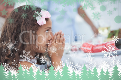 Composite image of little girl sitting praying at table