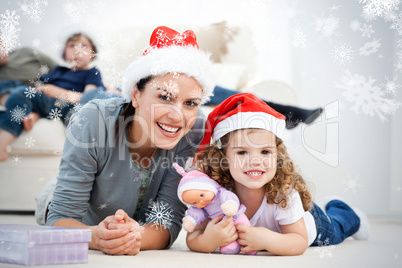 Happy mother and daugher at christmas lying on the floor
