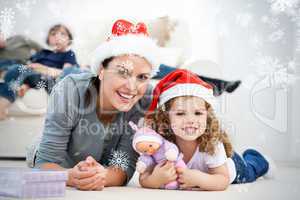 Happy mother and daugher at christmas lying on the floor