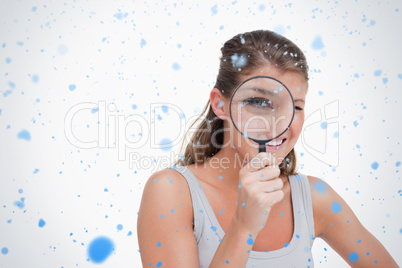 Woman looking through a magnifying glass